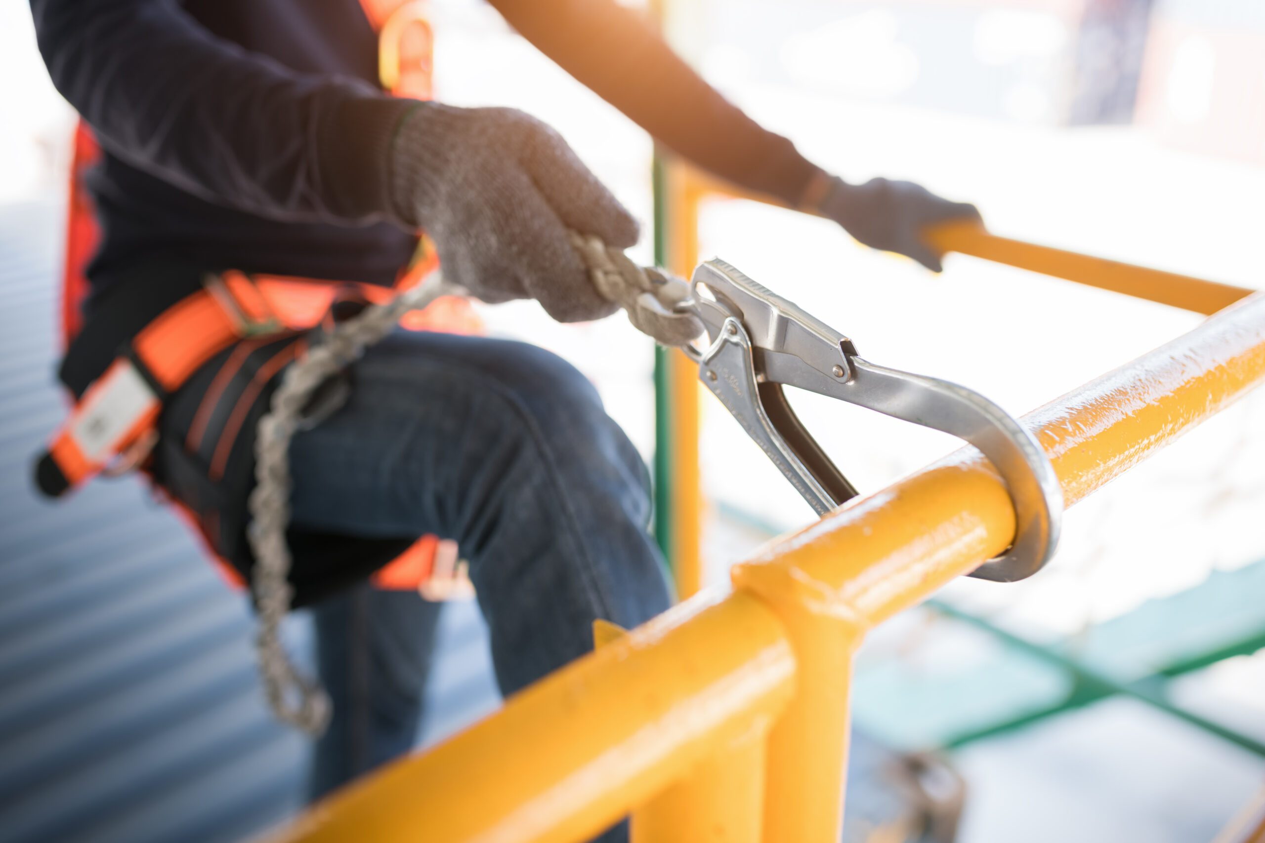 Construction worker wearing safety harness and safety line worki